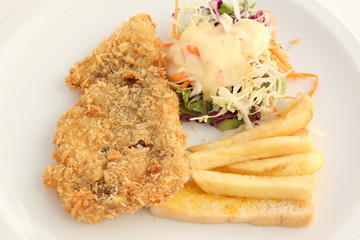 fried breaded fish steak with salad and french-fried