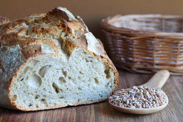 Sourdough artisan loaf with spelt seeds and proofing basket