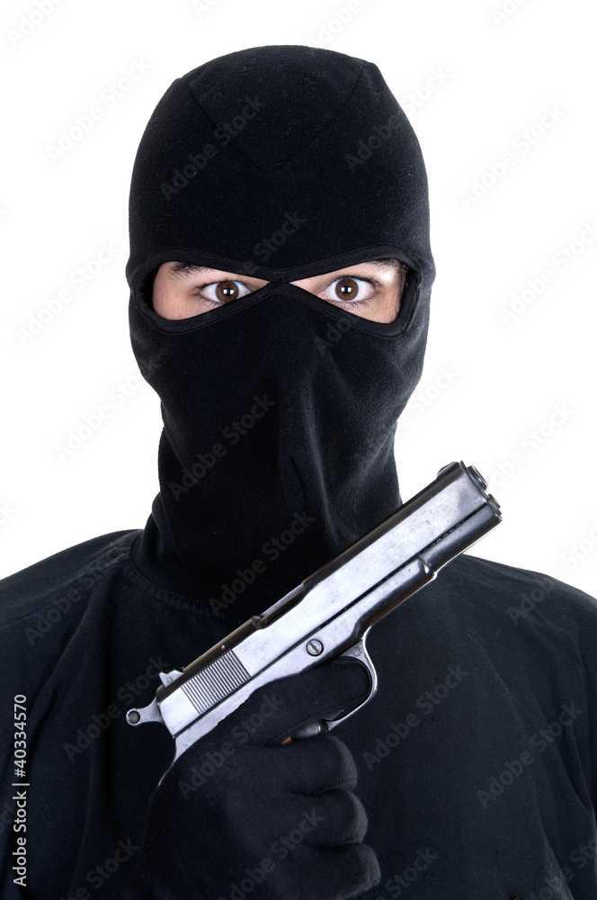 Wall mural Masked man aims with gun