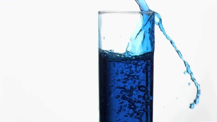 Blue liquid in super slow motion overflowing in a glass - Powered by Adobe