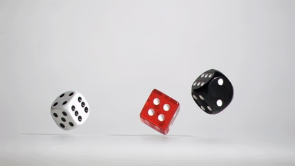 Three white red black dices in a super slow motion rebonding - Powered by Adobe