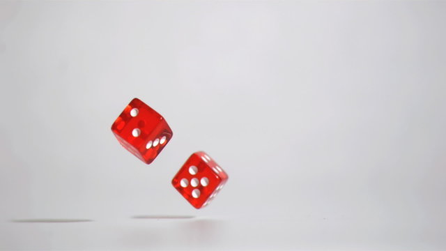 Two red dices  in super slow motion turning