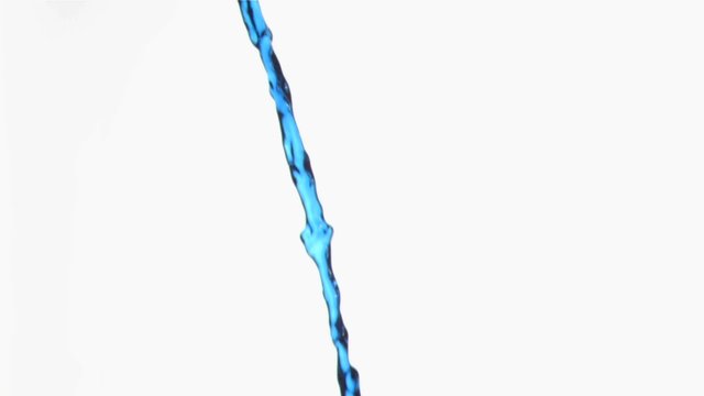 Blue liquid in a super slow motion flowing continuously