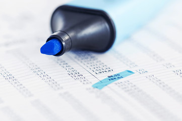 Page of stock market prices with highlighed text
