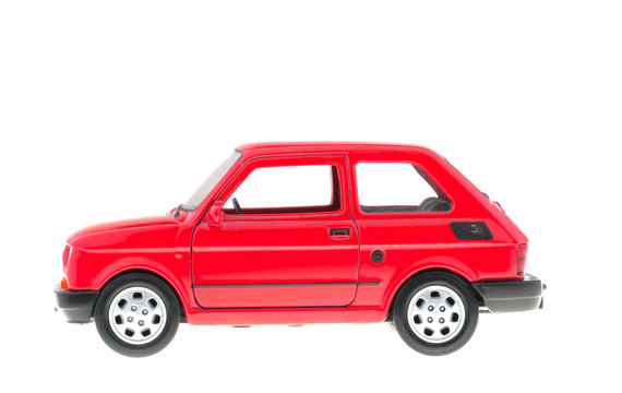 Small red car on white background.