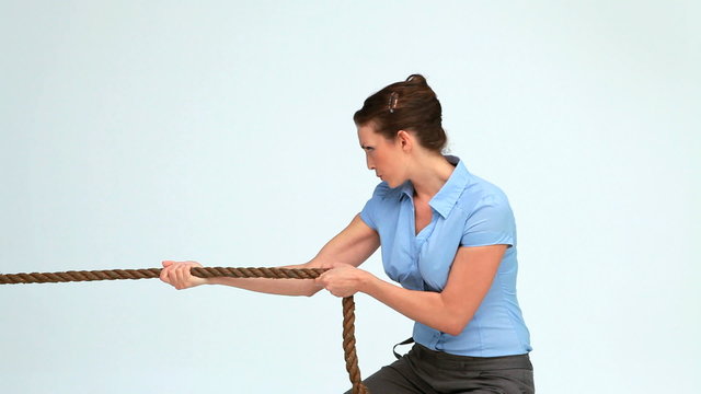 Young businesswoman pulling a rope