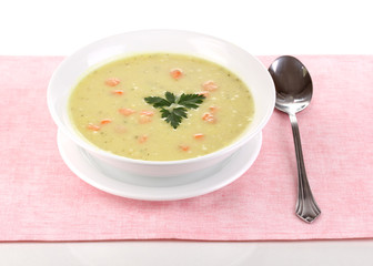 Tasty soup on pink tablecloth isolated on white