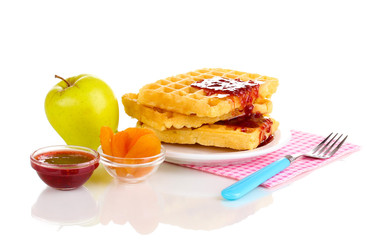 Tasty waffles with jam on plate isolated on white