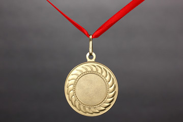 Gold medal on grey background