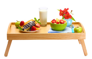 light breakfast on wooden tray isolated on white
