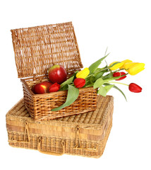 wicker basket of apples and flowers on a white background