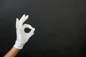 hand of a woman is showing a symbol