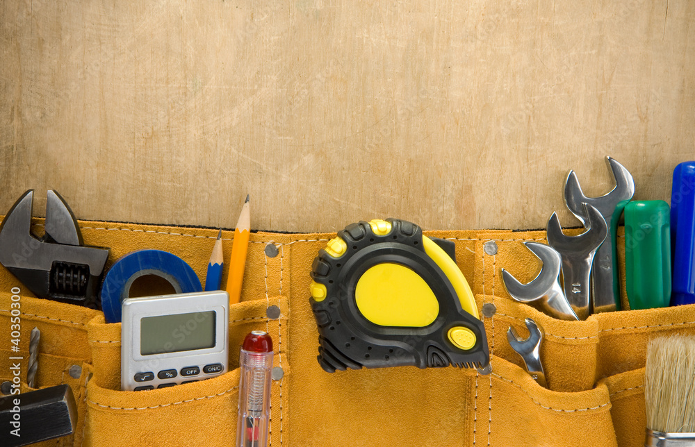 Wall mural tools in construction belt on wood