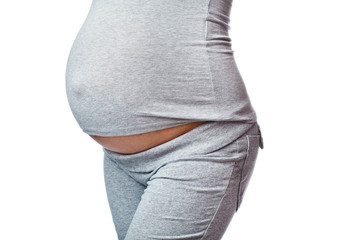closeup of 9 months pregnant woman over white
