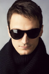Handsome man in sunglasses and black scarf