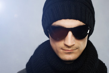 Stylish handsome man in dark sunglasses