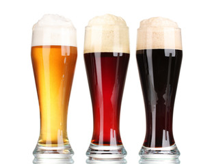 three glasses with different beers isolated on white