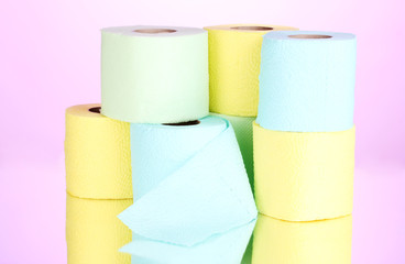 bright rolls of toilet paper on pink background