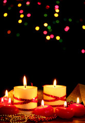 Beautiful candles on wooden table on bright background