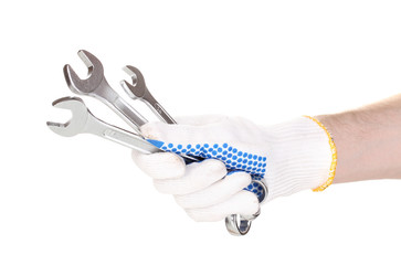 Wrenches in hand with protection glove isolated on white