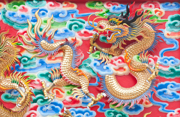 chinese dragon statue  on temple wall in Thailand