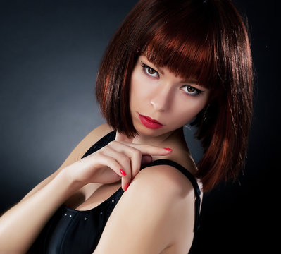 Beauty. Beautiful Red Hair Woman Over Dark Background