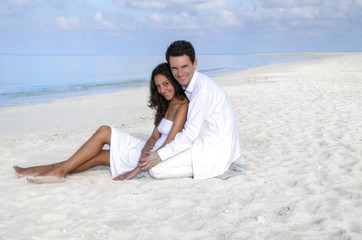 Sensual happy lovers in white clothes on the beach (Maldives)