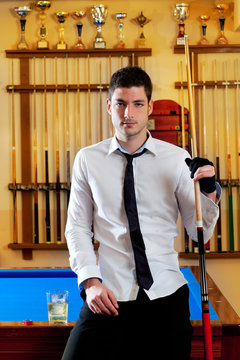 Billiard handsome young man with shirt cue and tie