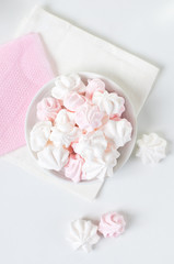 White and pink meringue on a plate