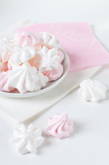 Obraz na płótnie Canvas White and pink meringue on a plate