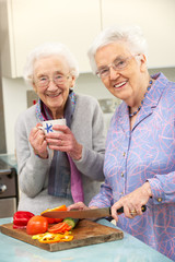 Senior women preparing meal together
