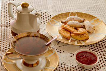 Homemade heap of cookies and cup of tee