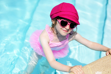 Cute little girl by a swimming pool