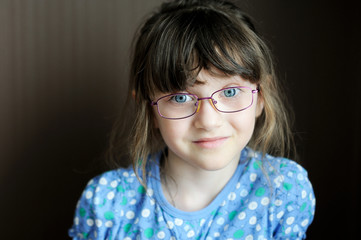 Portrait of happy little girl on dark background