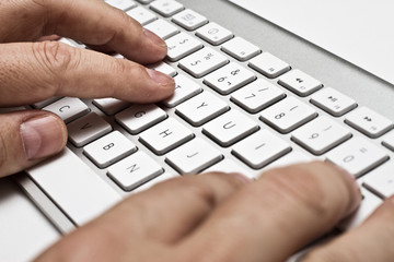 white computer keyboard with hands