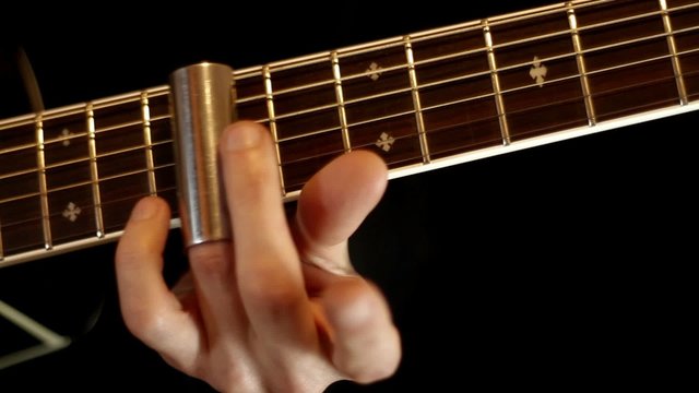 Finger play on guitar with slide
