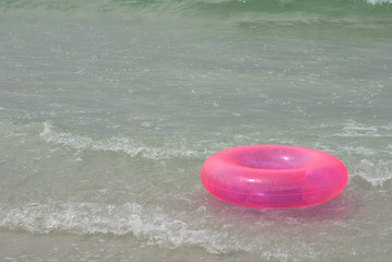 Pink Life Saver in Ocean Surf