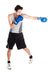 young boxer in gray shirt and blue boxing gloves