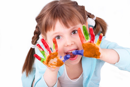 Little girl plays with her colored hands
