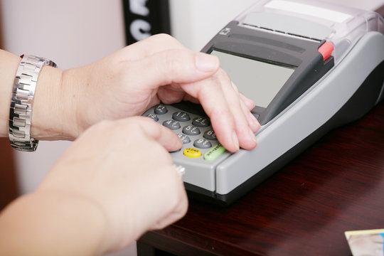 Human hand enter atm banking cash machine pin code