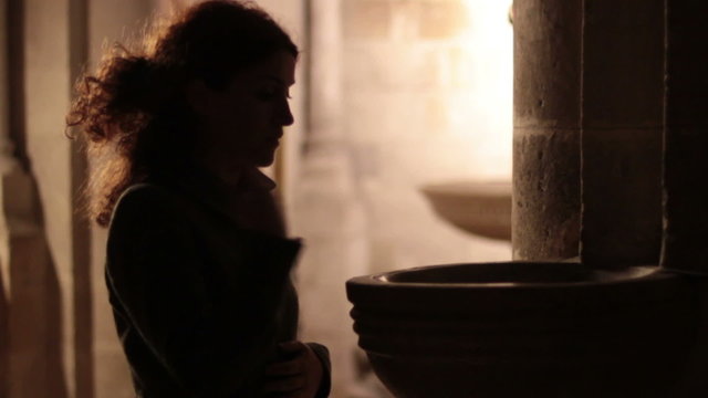 Woman goes to church - a sign of the cross