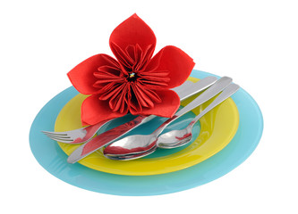 Fototapeta na wymiar A set of cutlery on a plate with a flower made ​​of paper na