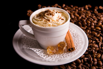 Coffee background and white cup isolated in black