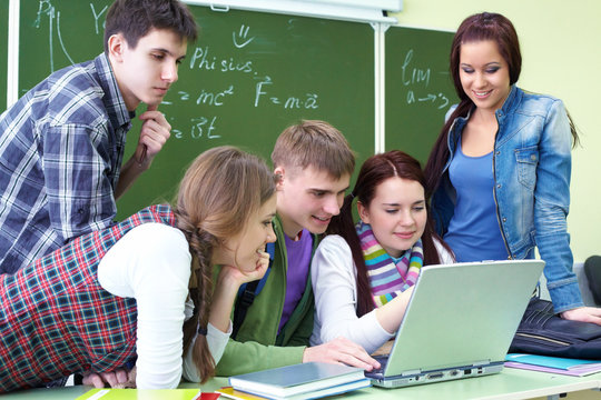 group of students studying with laptop