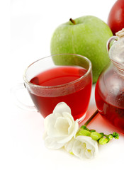 Healthy fruit Tea in a glass cup isolated in white. Shallow DOF.