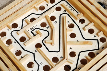 wooden labyrinth with holes on the path