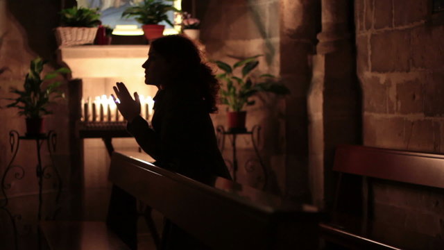 Woman praying in church