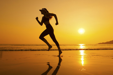 Fototapeta na wymiar Silhouette woman jogging on the beach