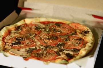 Pizza with mushrooms and tomatoes