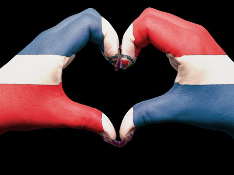 Heart and love gesture by hands colored in dominican flag for to